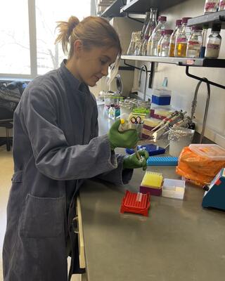 Boismier uses a pipette in the lab.