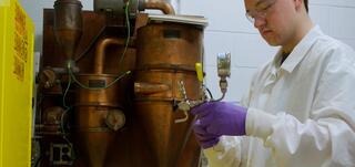 A researcher performing the AFEX pretreatment method