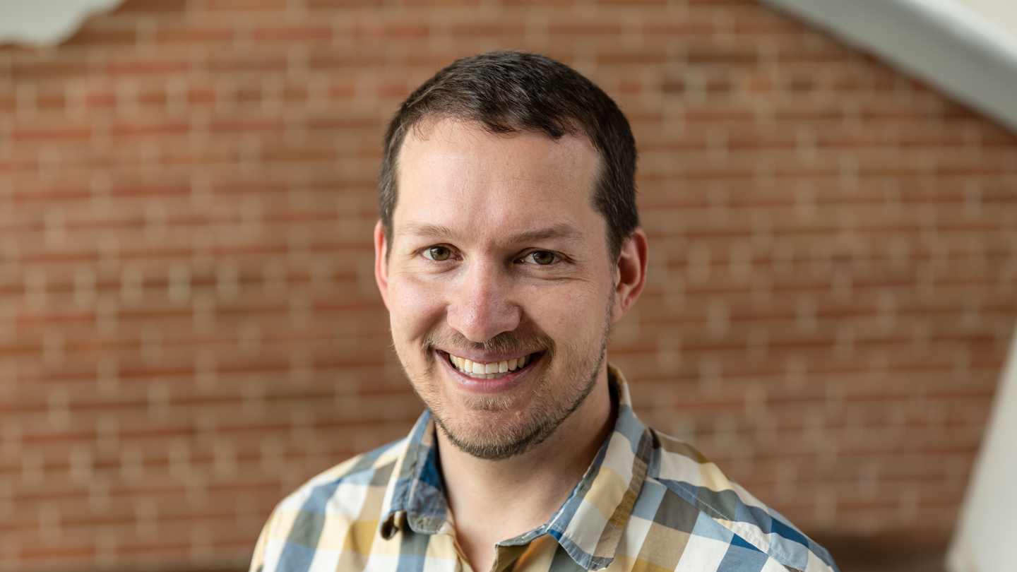 Smiling man in checked shirt