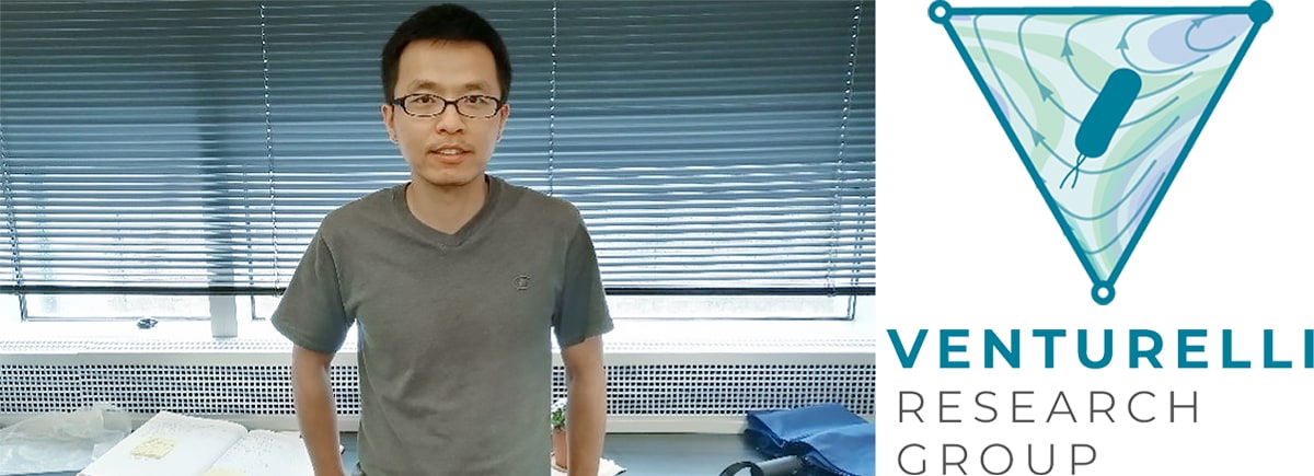 Jun Feng standing in front of his lab bench