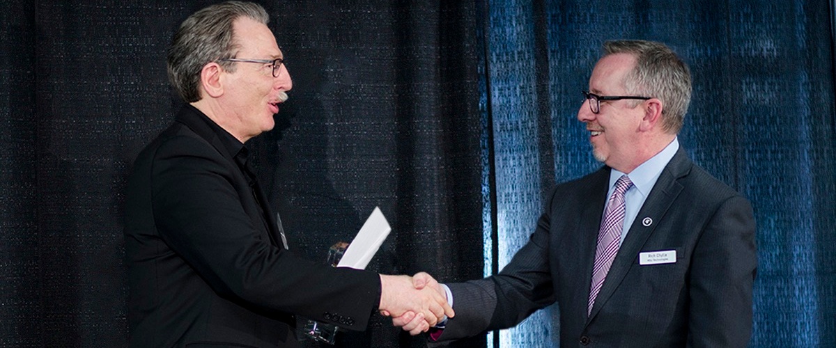 Christoph Benning accepting an award and shaking hands