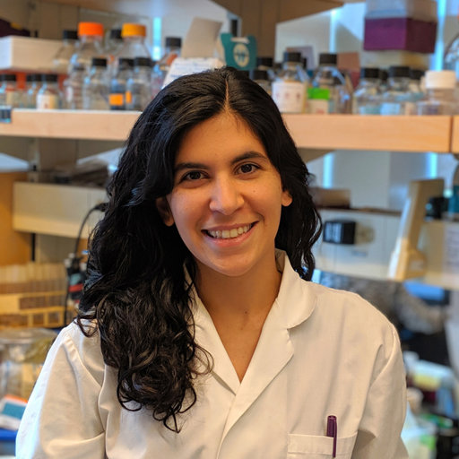 Linda Horianopoulos poses for a photo in a labcoat.