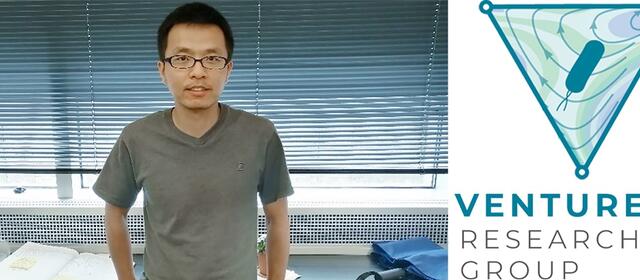 Jun Feng standing in front of his lab bench