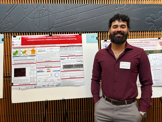 Bilbao stands in front of his poster