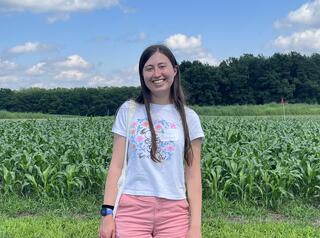 Bricker stands in front of a lush green field