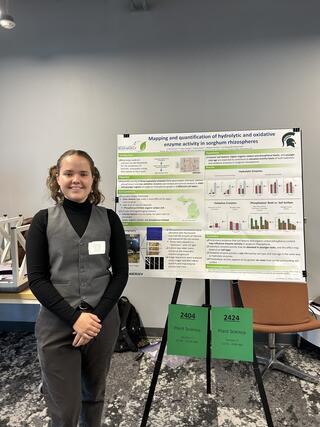 Winkelman stands in front of a scientific poster