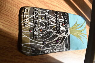 A clay tablet with a grassy plant and layers of long roots labeled from top to bottom "Classify," Cluster," "Filter," "Assemble," and "Clean"