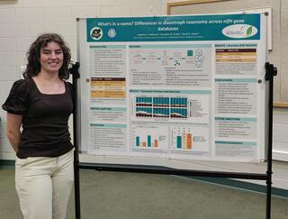 Pellicano stands next to her poster at a symposium