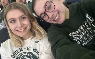 Two blonde women smiling in MSU sweatshirts.