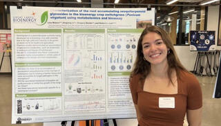 Lina Blanco stands to the right of her research poster