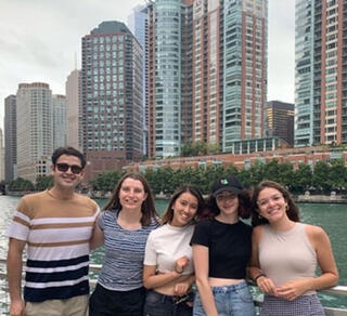 GLBRC 2022 Summer Undergraduate Research Program participants pose in front of a river in an urban setting.