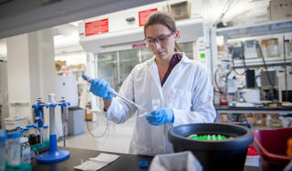 Rebecca Smith pipetting in a lab at the Wisconsin Energy Institute