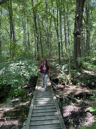Maggie Jones hiking through a forest