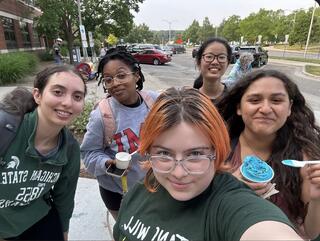 A group of young students pose for a selfie.