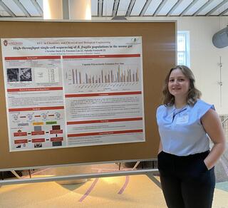 Christine Stark standing in front of a poster.
